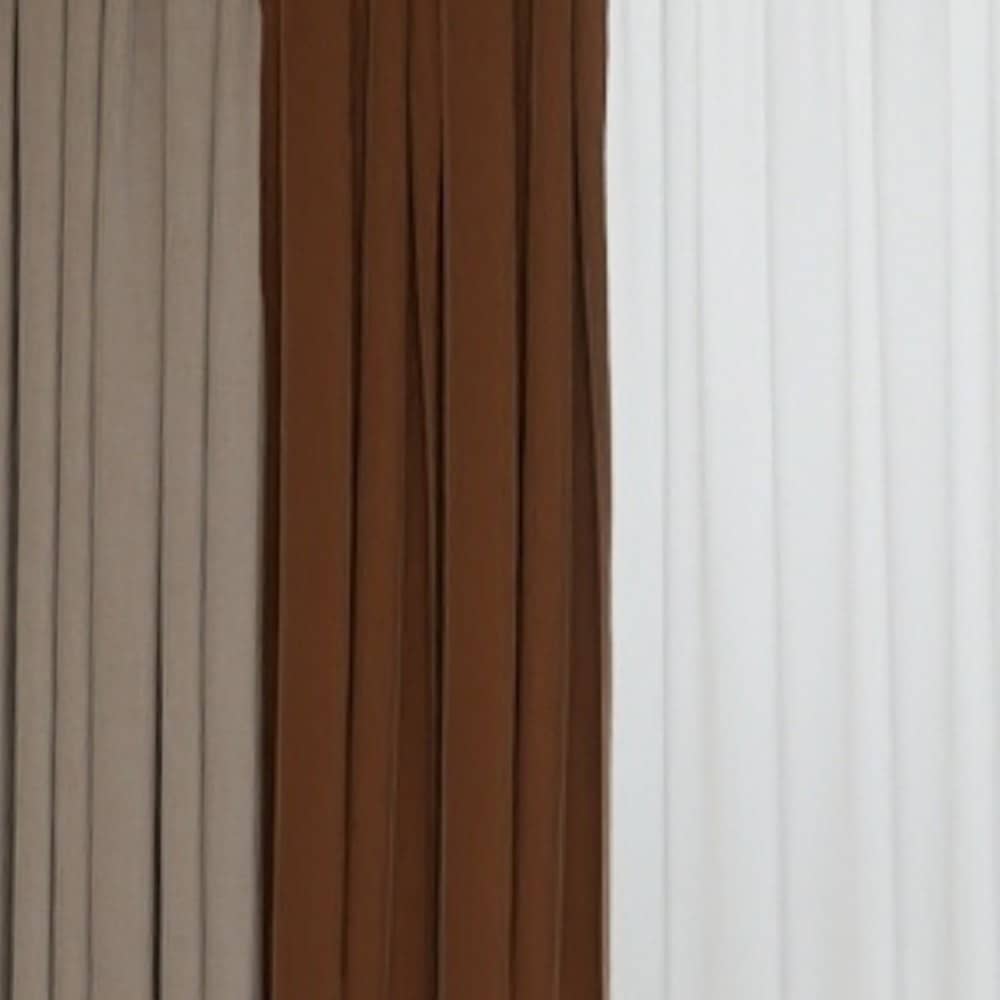Layered drapery: a warm rust curtain beside sheer voile