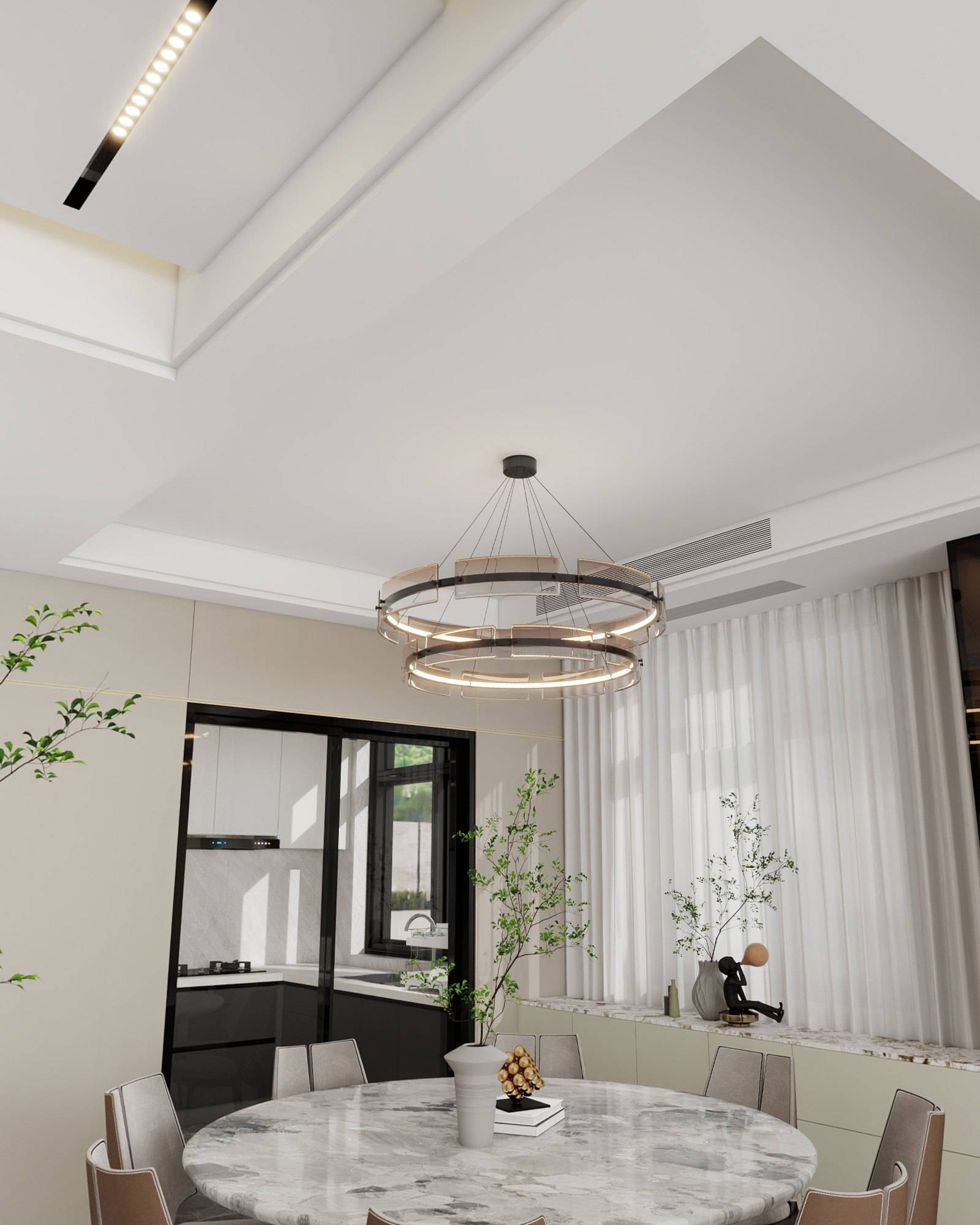 Layered ring pendant suspended over a round marble dining table