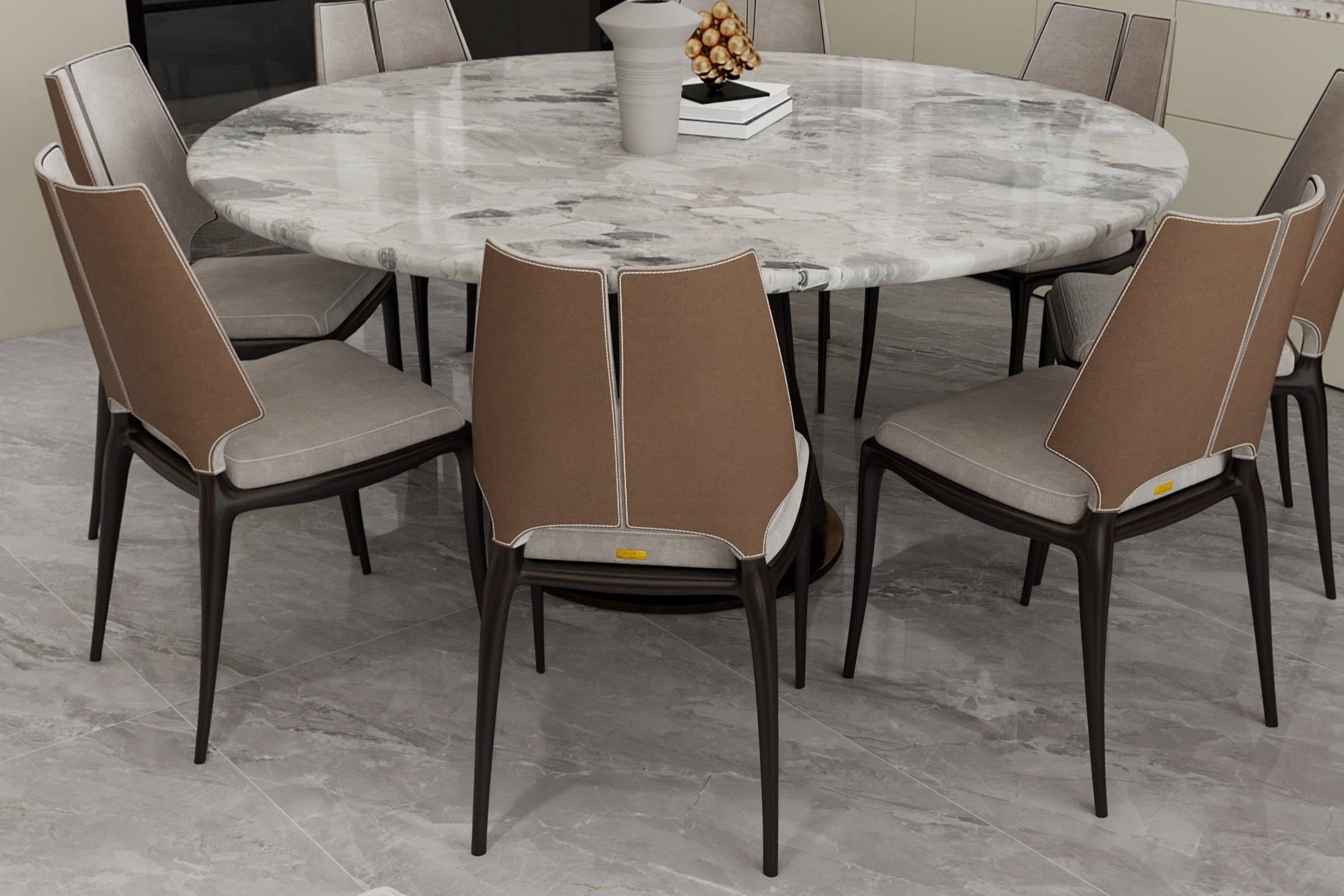 Round marble dining table surrounded by leather-backed dining chairs