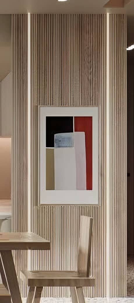 Fluted timber-clad column with integrated linear lighting and a framed artwork