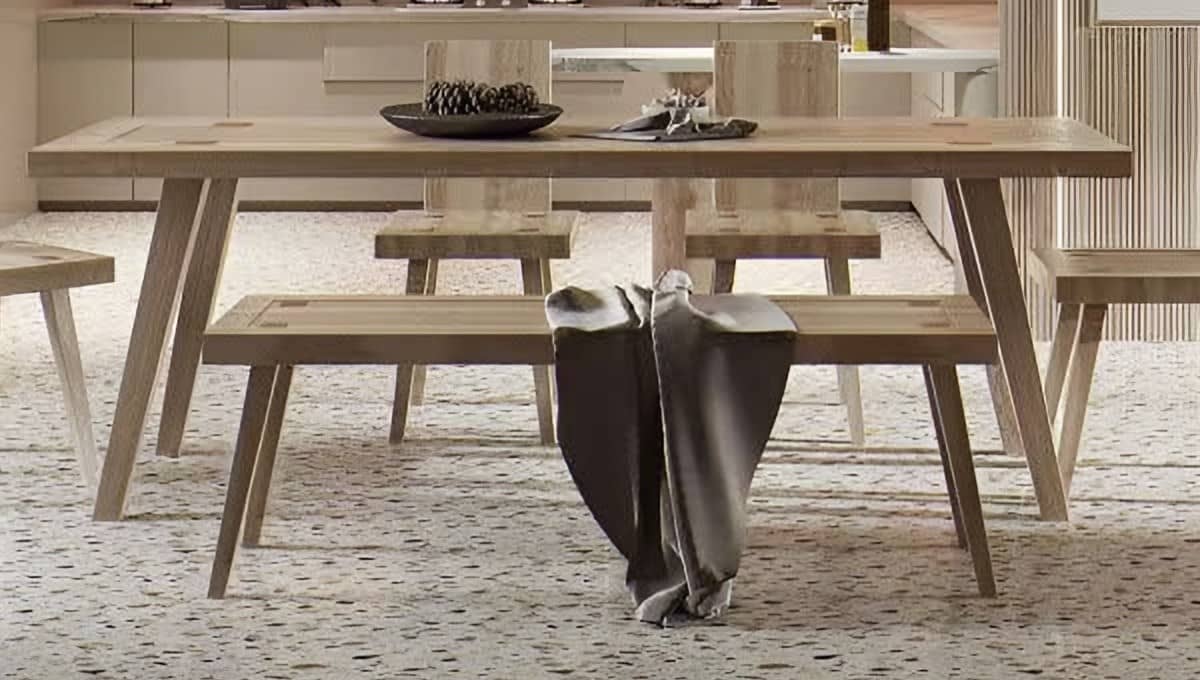Pale timber dining table with a matching bench on a terrazzo floor
