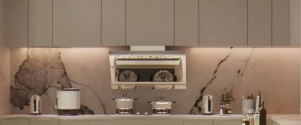 Kitchen run with flush taupe cabinetry and a dramatically veined stone backsplash