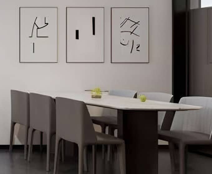 Stone-topped dining table with grey upholstered chairs beneath a series of framed ink artworks