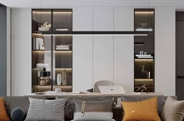 Wall of flush white cabinetry with two lit glass-fronted display columns