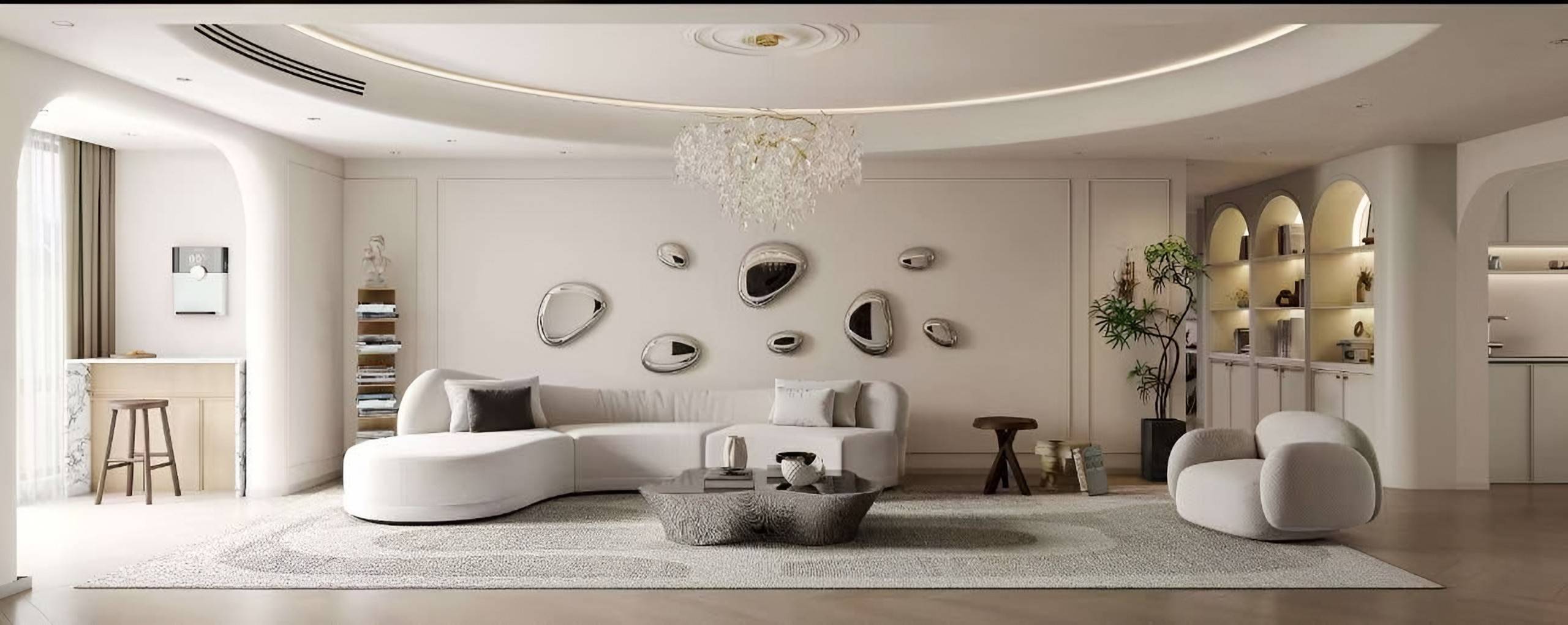 Ivory living room with a curved sofa, a cluster of pebble-shaped mirrors, a crystal chandelier and arched lit shelving