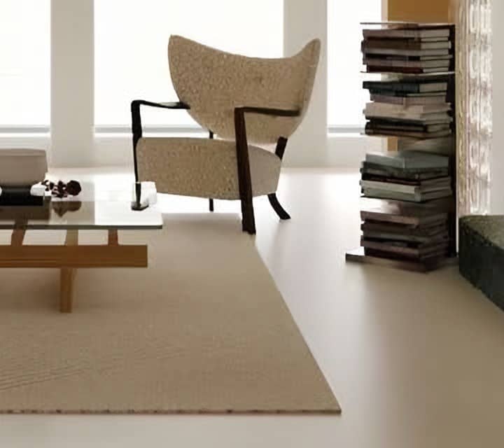Bouclé wingback armchair before arched windows