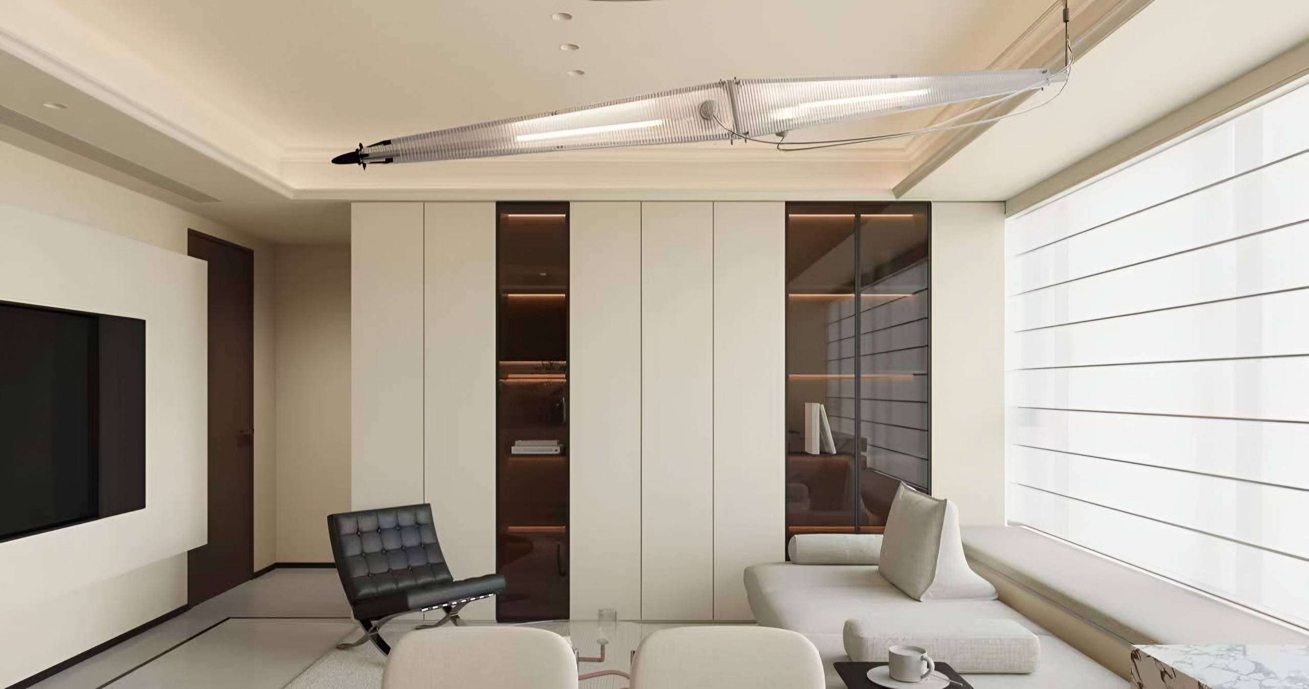 Living space with a sculptural glass pendant, a media wall and flush cabinetry with dark glass inserts