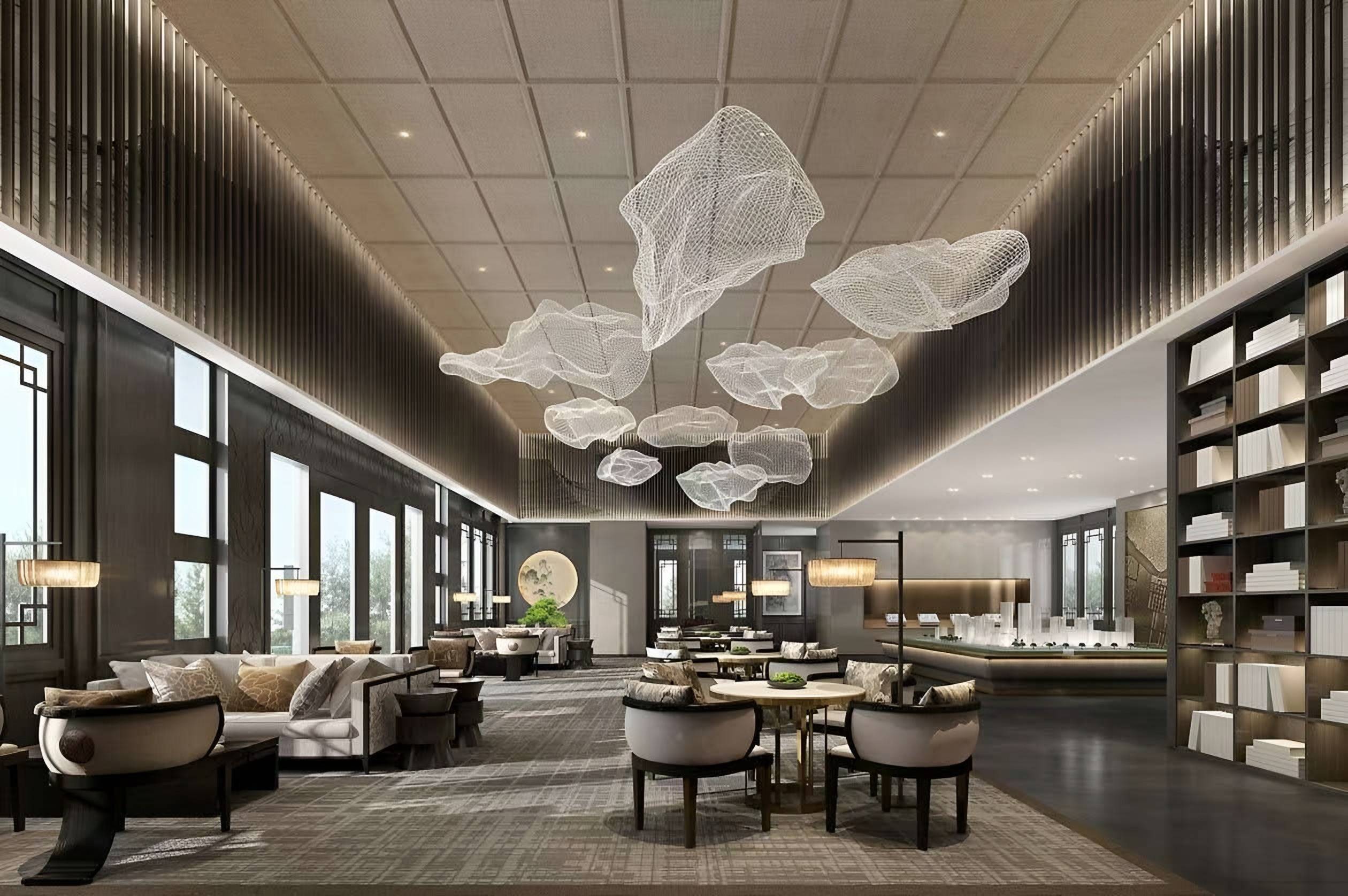 Double-height clubhouse lounge with suspended mesh sculptures, a timber grid ceiling, lounge seating and full-height bookshelves